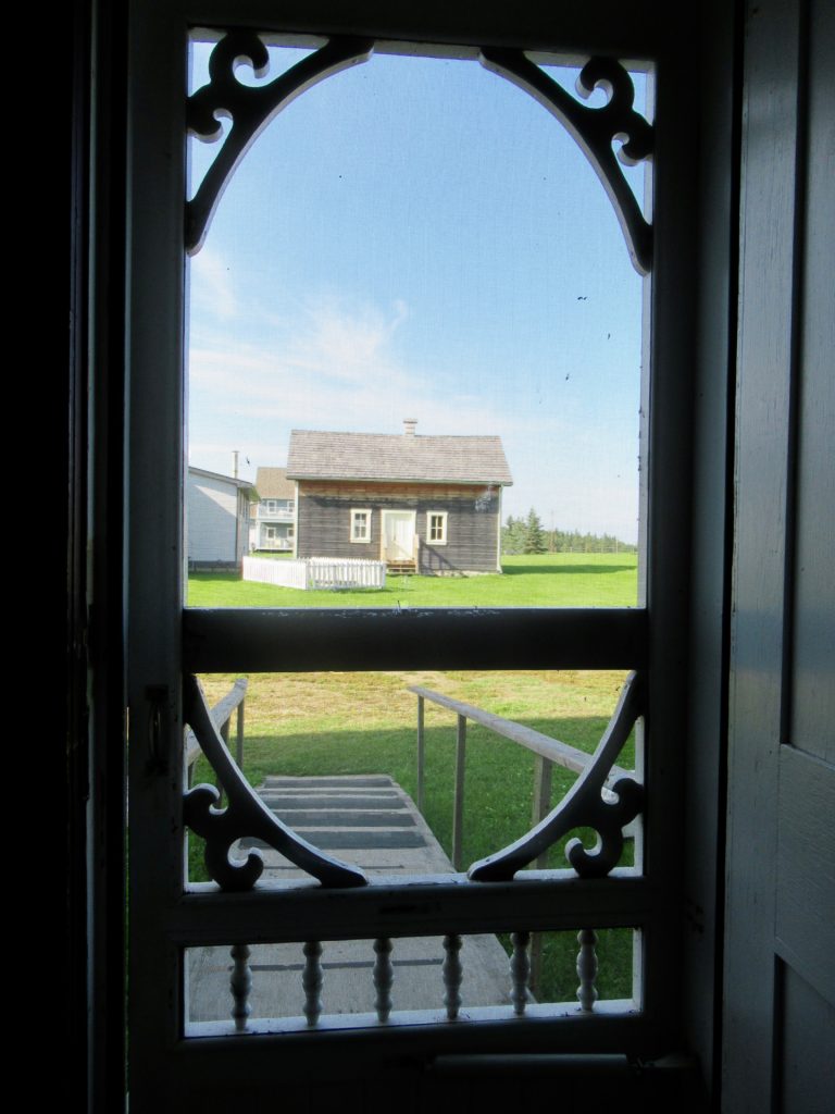 View from kitchen screen door of convent at Lac La Biche Mission