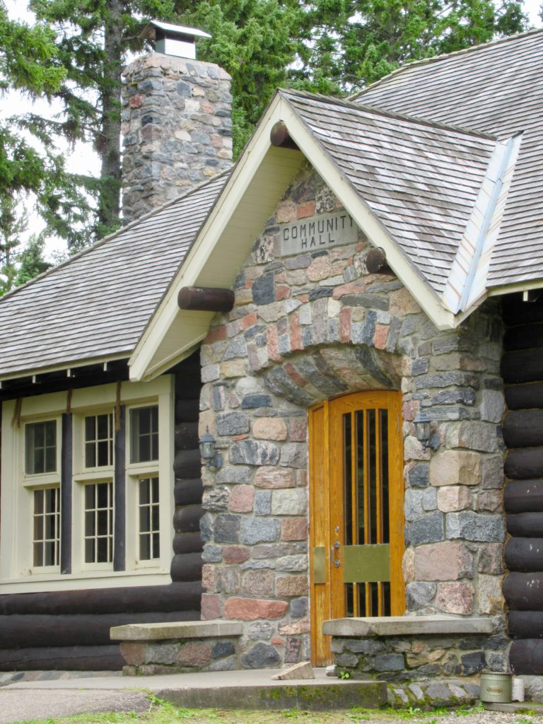 Stone entrance to dark brown log building