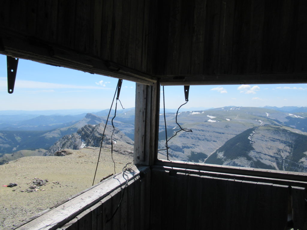 View of mountain ranges from inside abandoned fire lookout