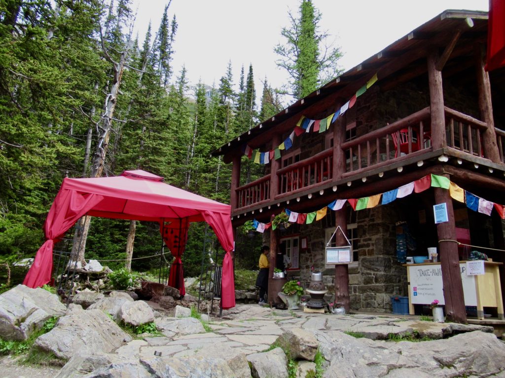 Old wood and stone teahouse with colourful prayer flags