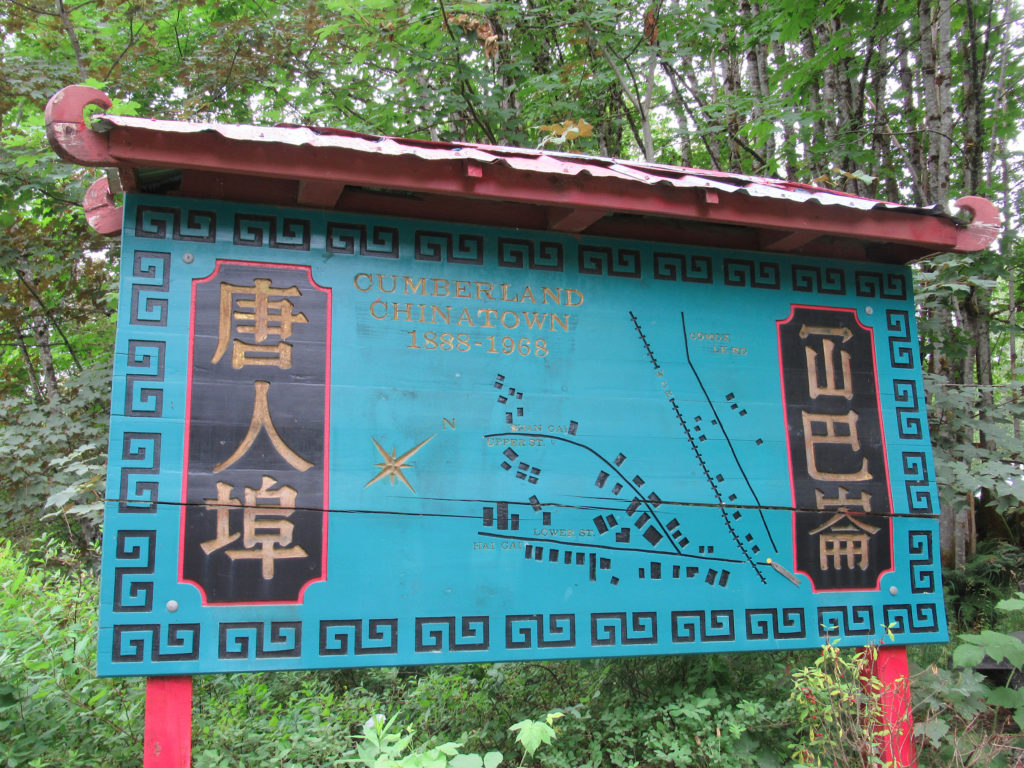Turquoise blue sign with Chinese lettering marking historic Cumberland Chinatown.
