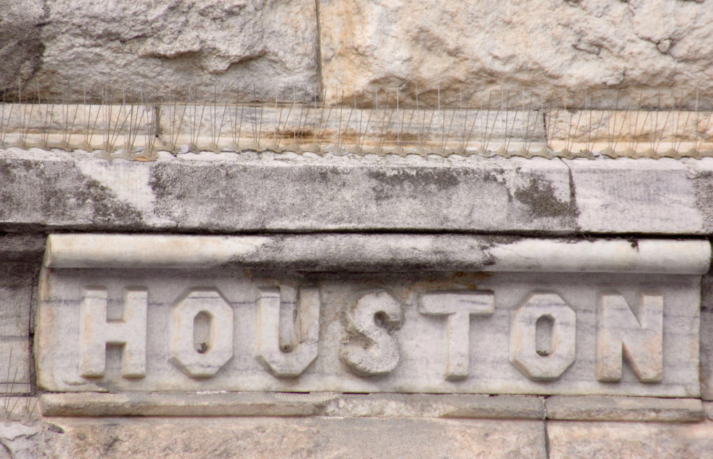 Marble stone building with name "Houston" carved into it.