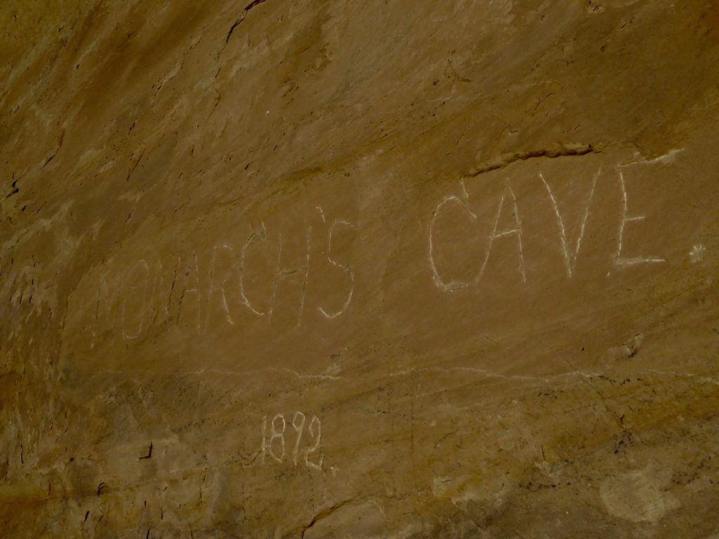Carving on rock wall reading : Monarch's Cave 1892