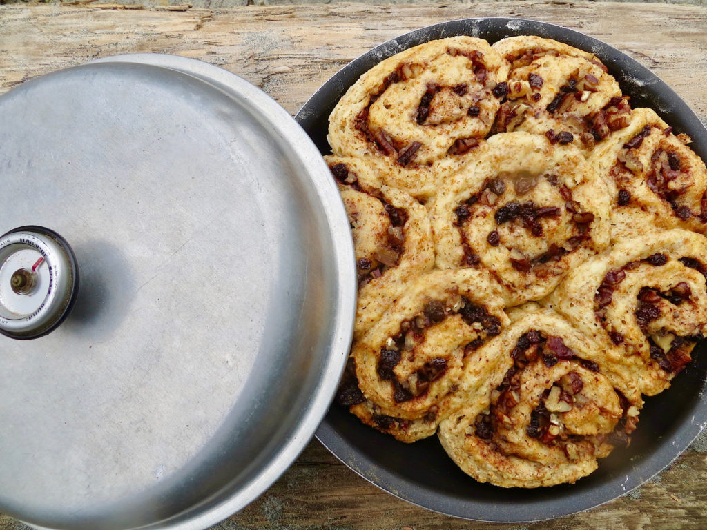 Fresh-baked cinnamon buns in pan of stovetop oven.