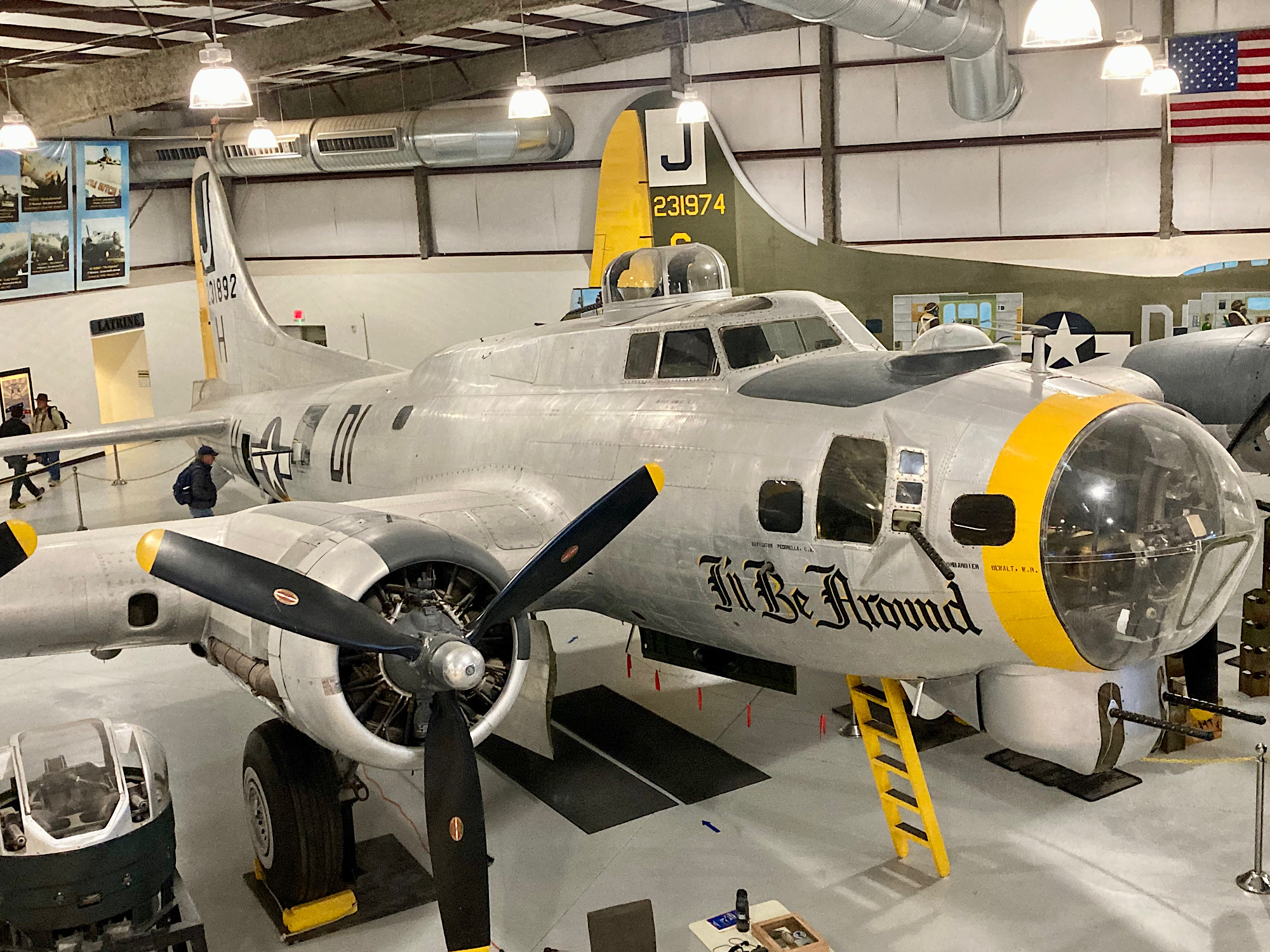 Grey and Yellow painted B-17 bomber named "I'll Be Around" in hangar