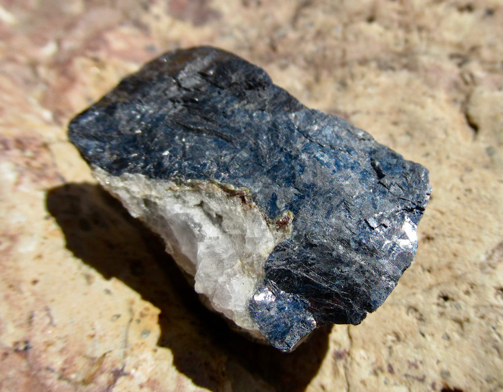 A piece of greyish black and white rock.