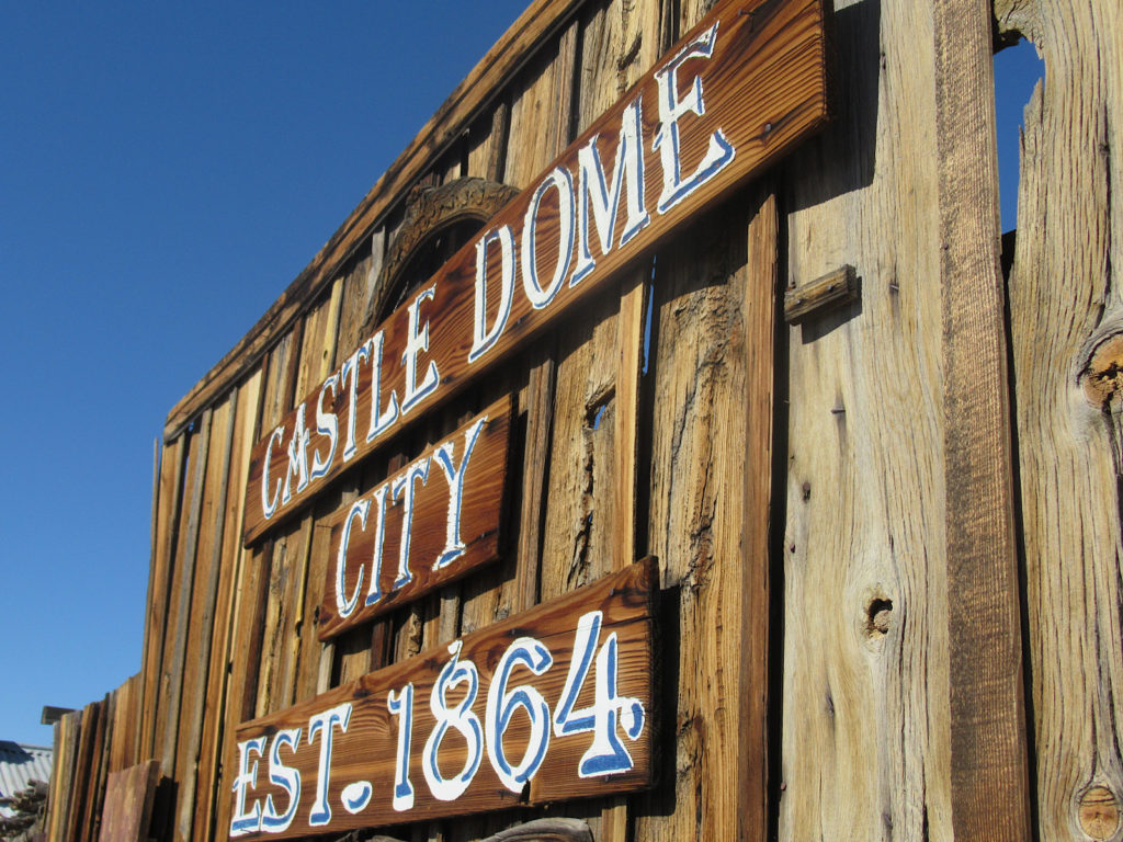 Wooden sign reading Castle Dome City Est. 1864