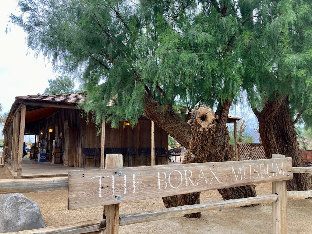 Small wooden building with sign in front reading: The Borax Museum 