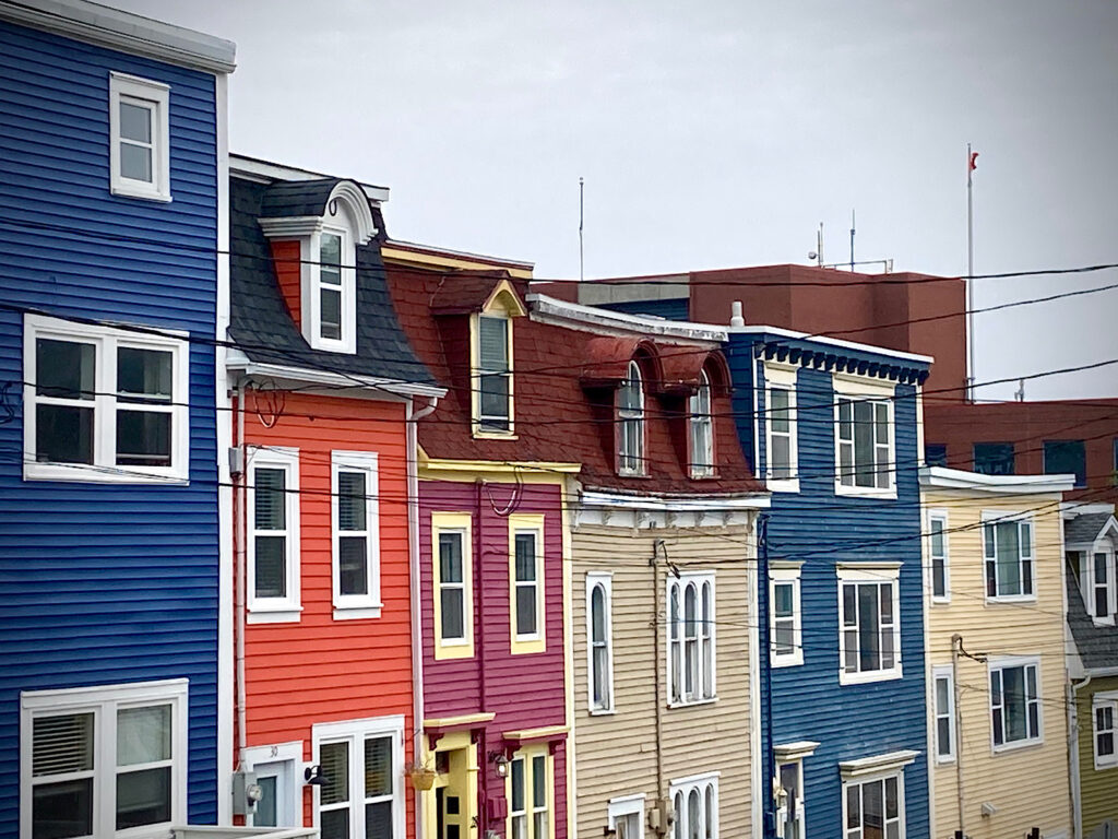 Brilliantly coloured blue, red, purple and olive green rowhouses.