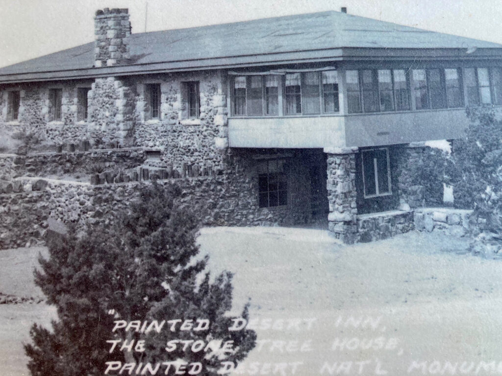 Black and white photo of old stone building with words "Painted Desert Inn, the Stone Tree House, Paint Desert Nat'l Monument" written in white across bottom of image.