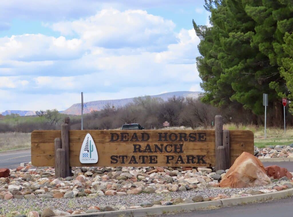 Wooden entrance sign reading: Dead Horse Ranch State Park.