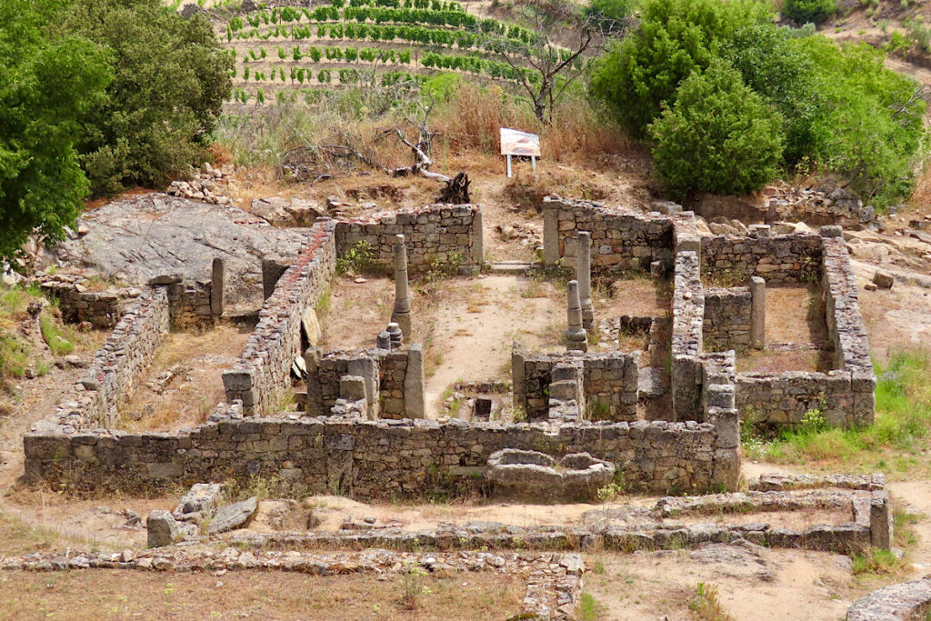 Stone ruins above terraced hillside.