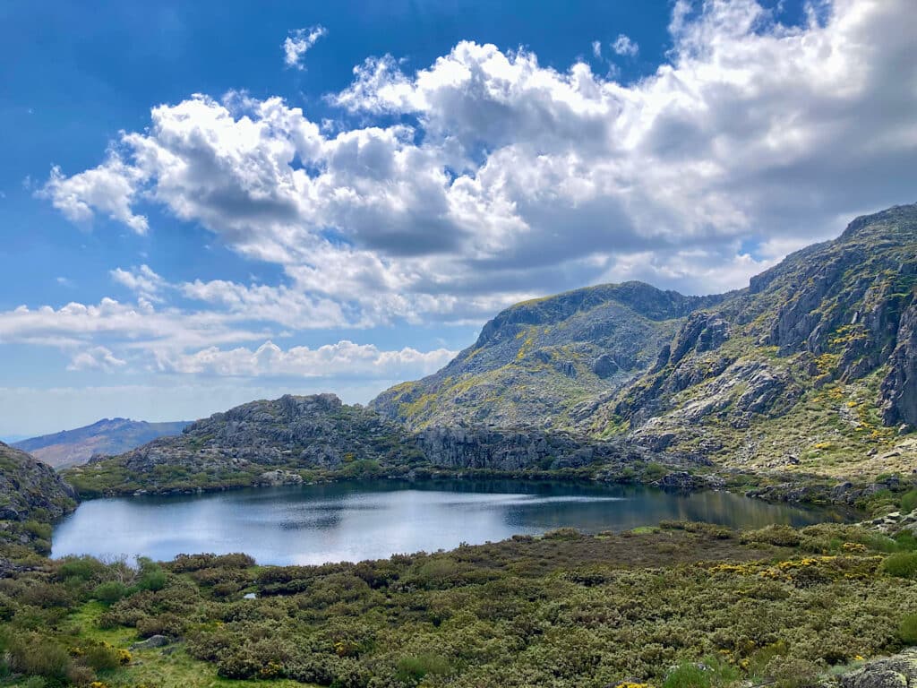 Lake in a high valley surrounded by mountains.