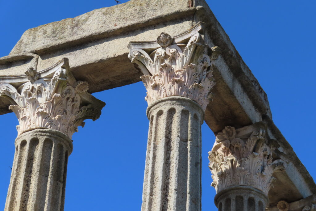 Fluted stone columns beneath delicately carved caps.