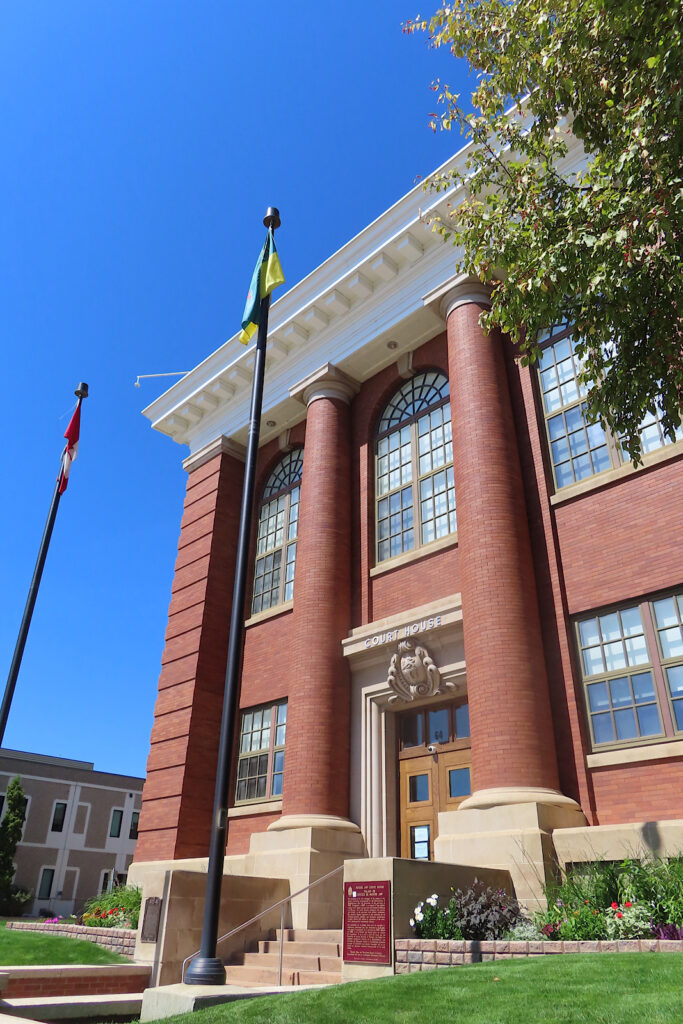 Imposing brick building with round columns on front.