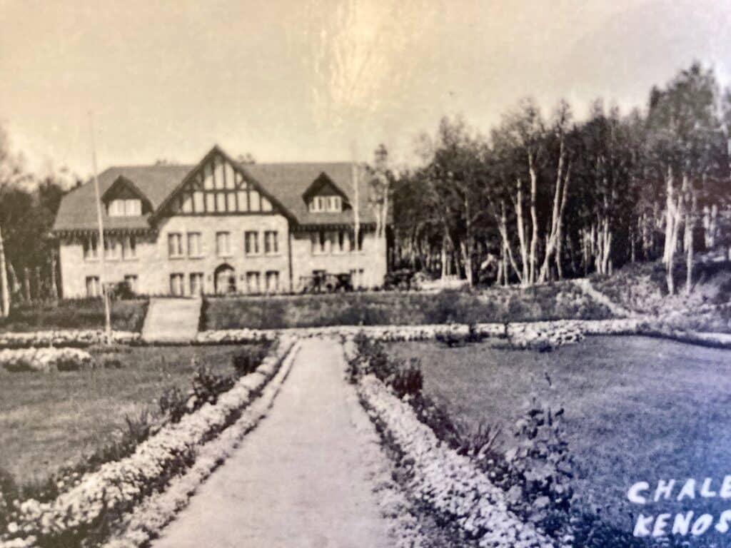 Black and white photo of path leading to large stone building.