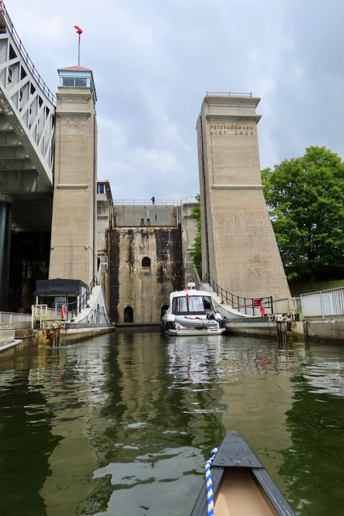 Large concret structure with words Peterborough Lift Lock written on side and canoe approaching entrance.