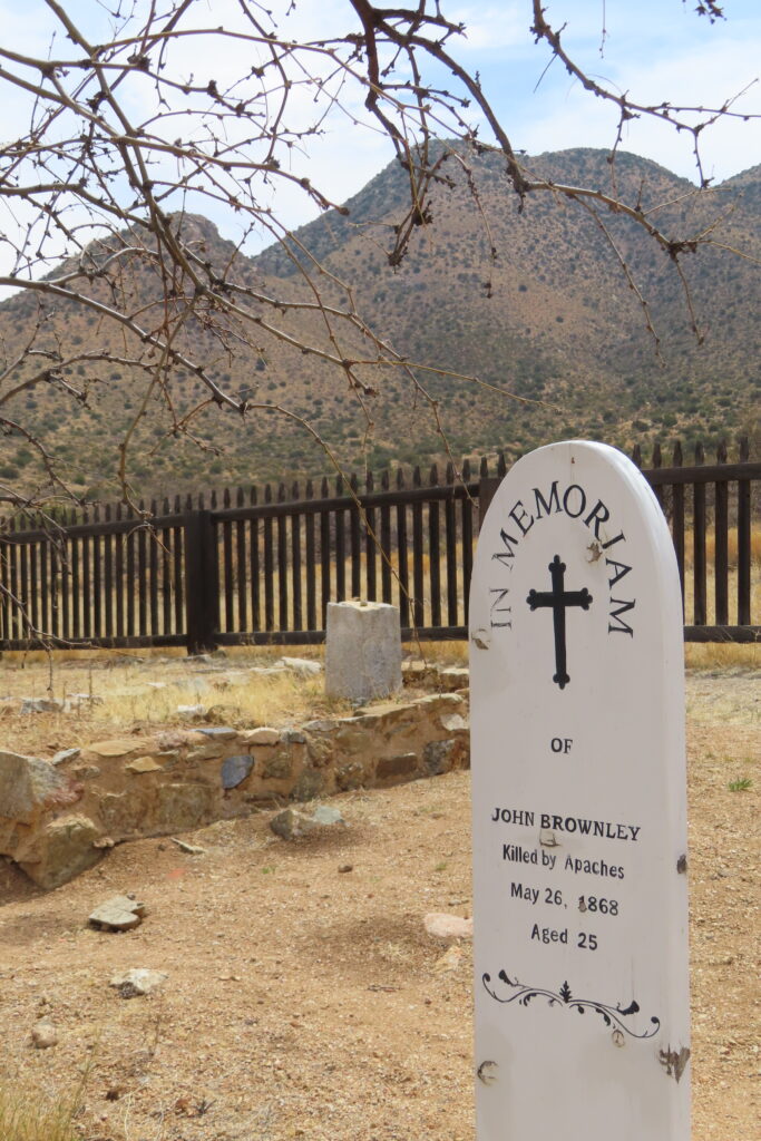 White grave marker reading: In Memorium, John Brownley. Killed by Apaches May 26, 1868. Age 25.