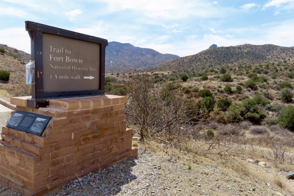 Sign on brick base reading: Fort Bowie National Historic Site 1.5 mile walk.