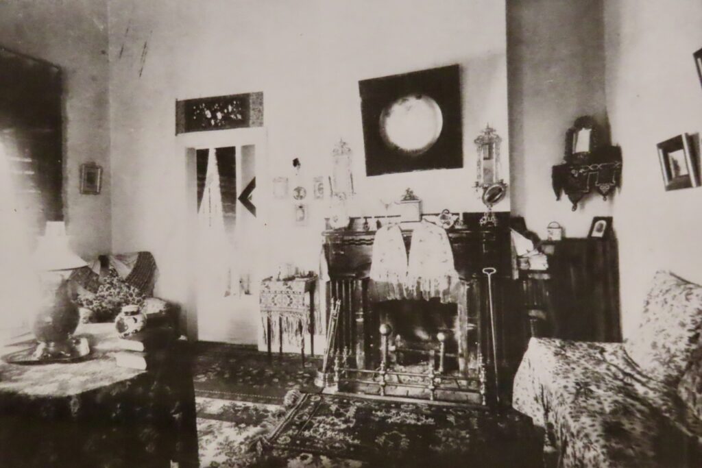 Black and white photo of inside historic home living room.