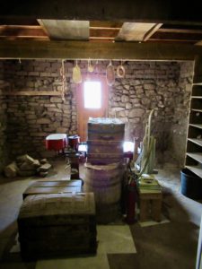 Old stone room with trunks and shelves for storage