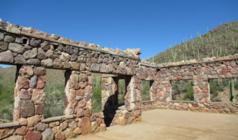 House frame with cement floor, stone walls, large window openings and no roof