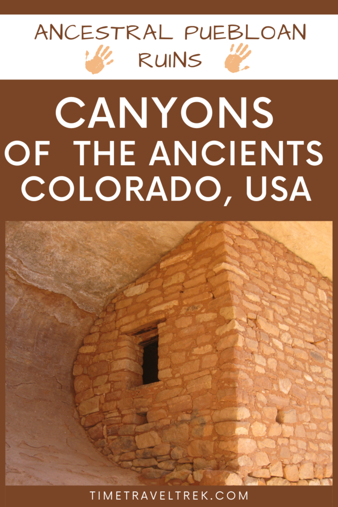 Pin image for Time.Travel.Trek. post with photo of reddish brown stone structure built into curve of cave wall. Text reads: Ancestral Puebloan Ruins. Canyons of the Ancients Colorado, USA. 