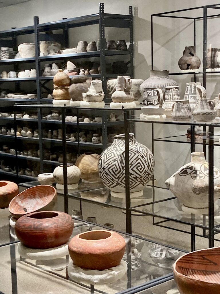 Red, white and grey pottery on stands.