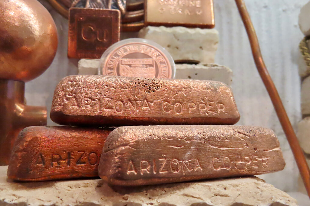 Three copper bars with word "Arizona" stamped on sides.