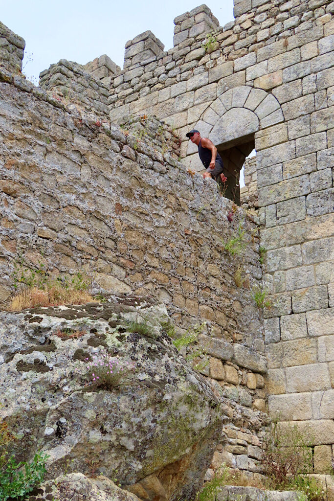 Man coming out of doorway in castle tower.