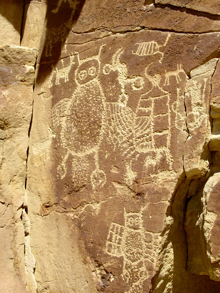 Images pecked into red sandstone include an owl with one cross-eye.