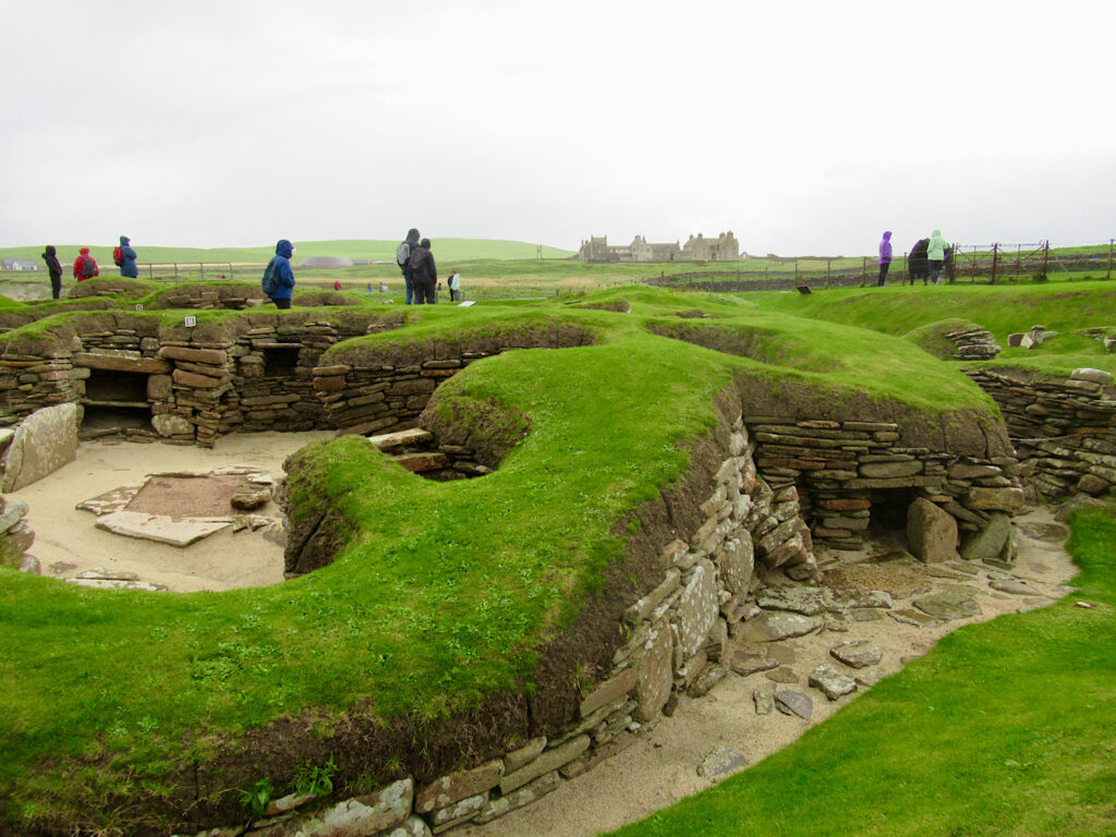 Grassy mounds with subterranean rock lined passageways and buildings.