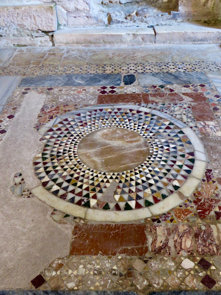 Intricate circle pattern created with coloured cut pieces of marble.