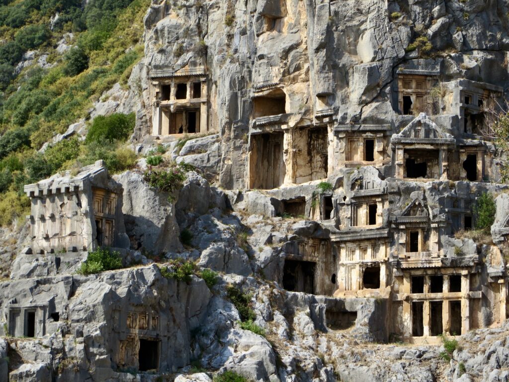 Buildings carved in sheer rock wall.