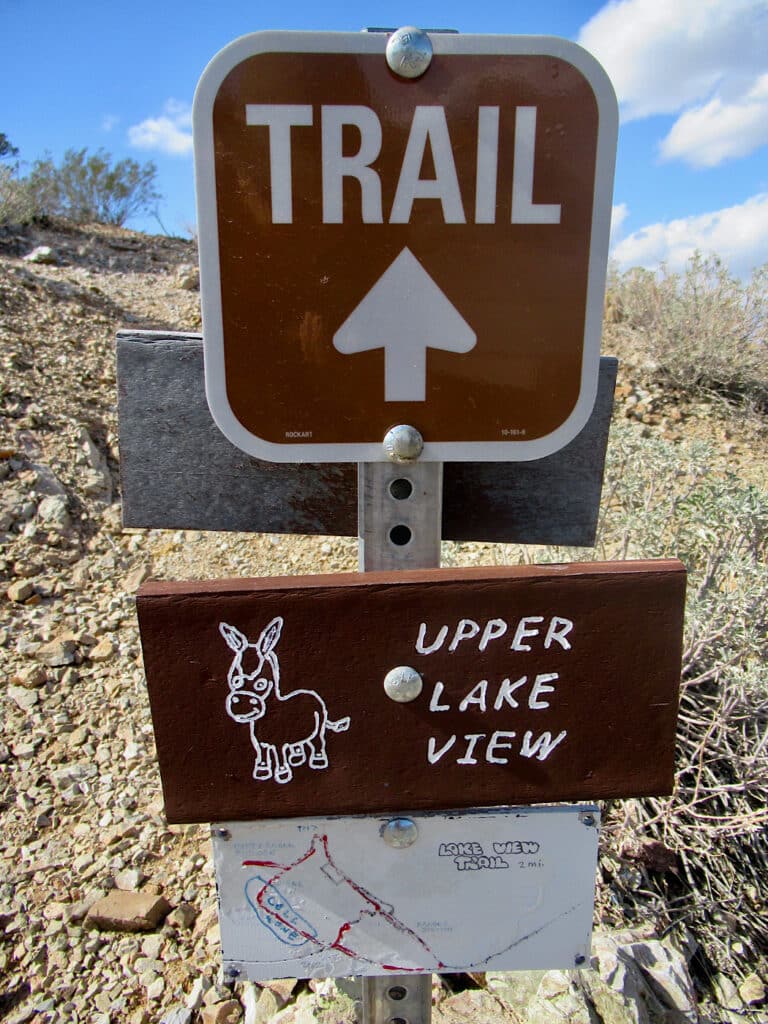 Trail sign reading "Upper Lake View" with image of burro beside.