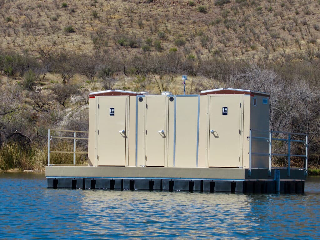 Floating portable outhouse on lake.