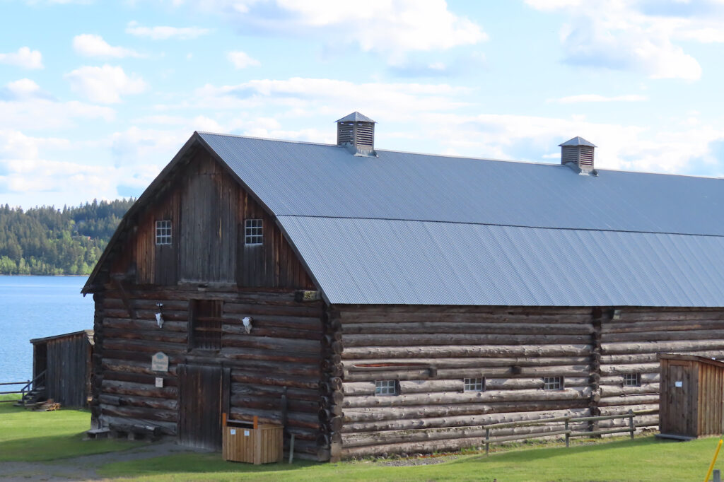 Large wooden barn with metal roof.
