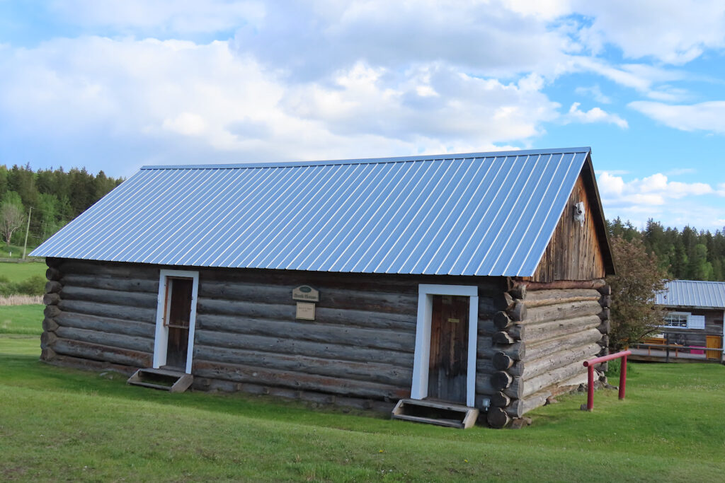 Wooden building with two doors and metal clad roof.