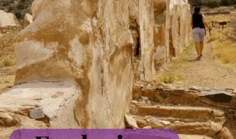 Pin image of woman walking beside remains of beige adobe walls. Text reads: Arizona TimeTravelTrek.com. Exploring Fort Bowie Natiional Historic Site.