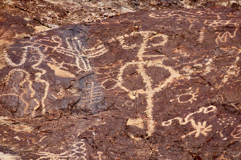 Close up image of images inscribed on rock.