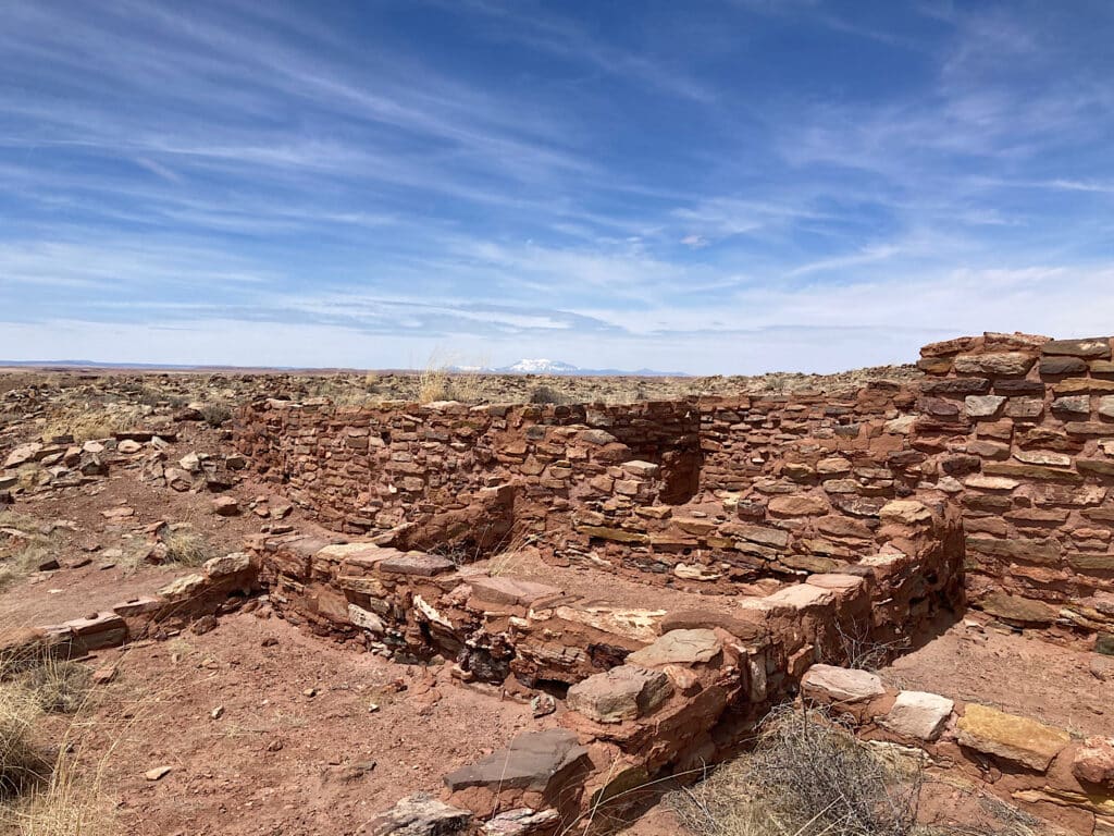 Rock ruins on a flat under blue sky.