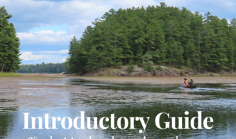 Pin image for TimeTravelTrek.com with photo of a canoe on a weed-choked lake. Text reads: Canoeing Killarney, Introductory Guide (and what to do when plans change). Ontario, Canada.