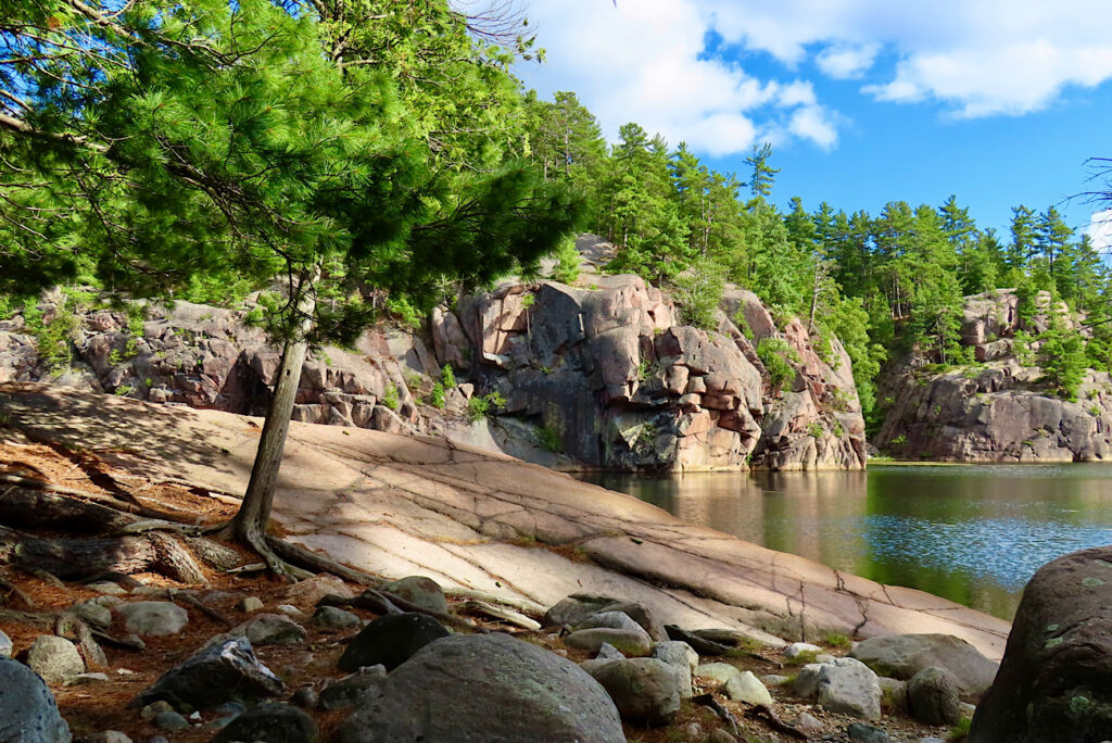 Red rock sloping into lake.
