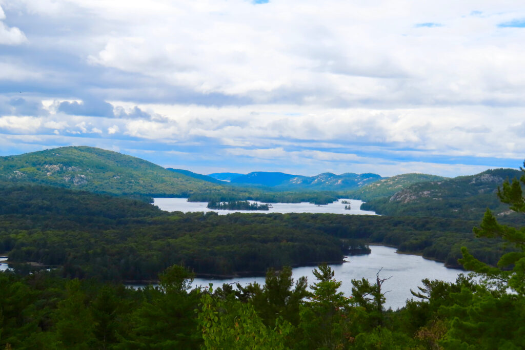 High vantage view overlooking lakes and forested hills.