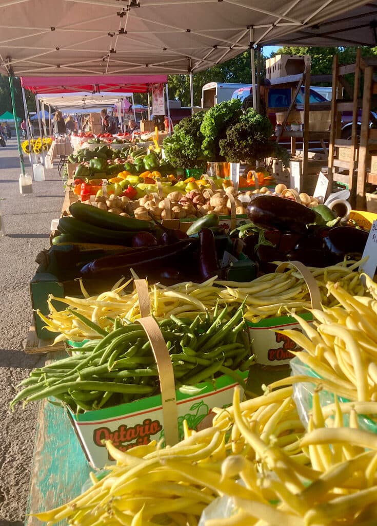 Selection of bright vegetables in an outdoor market.