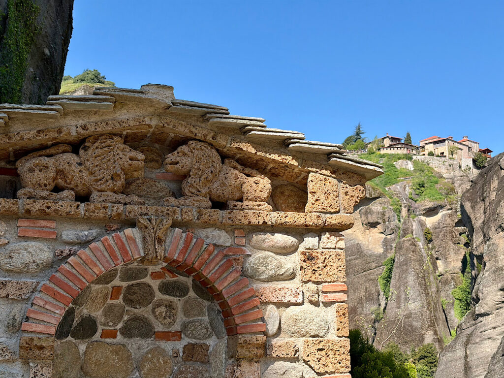 Rock building with images of lions.