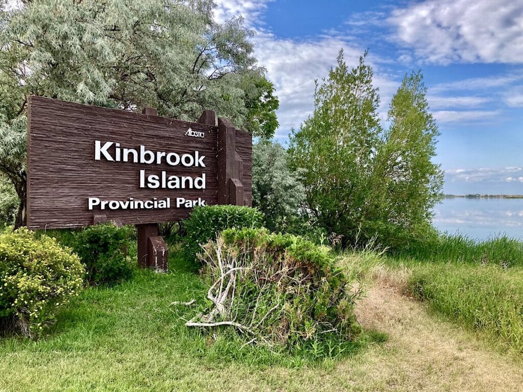 Wooden sign in front of trees and wetlands reads: Kinbrook Island Provincial Park